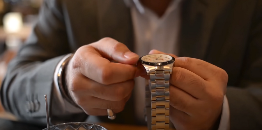 a man holding a watch