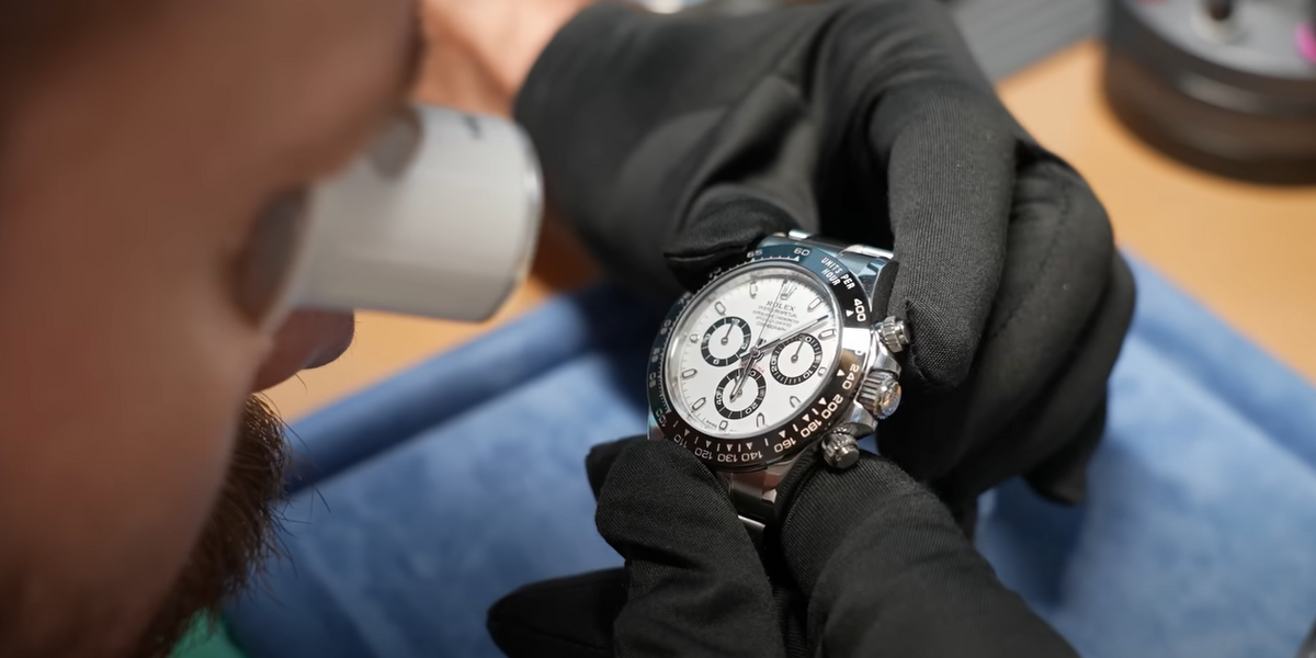 a man checking on a Rolex watch