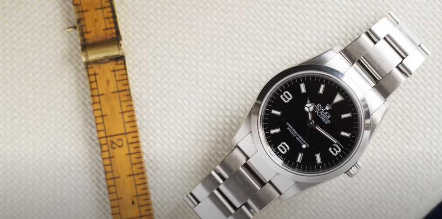 a Rolex Explorer with a measuring tape on the side