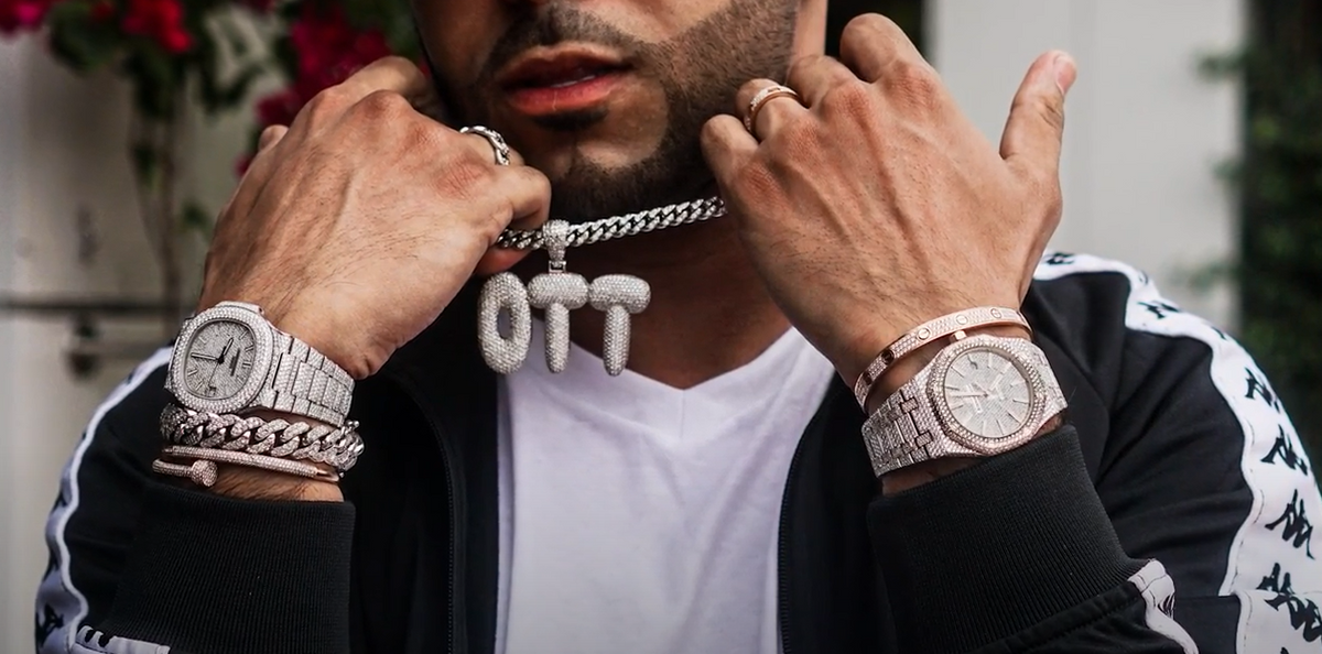 a man wearing luxurious watches in both hands